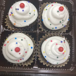 four cupcakes in a chocolate box