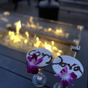 two cocktail glasses with flowers on them