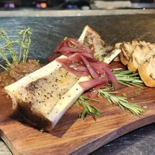 Bone Marrow appetizer with prime rib pate, house picked onions, Barrio Bread