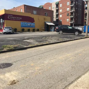 a city street with cars parked on the side of the road