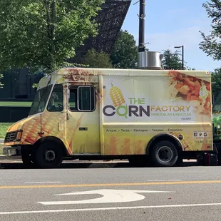 two food trucks parked on the side of the road