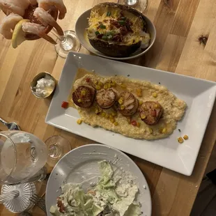 Scallops and risotto backed potato and wedge (partially eaten).