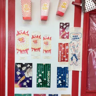 a bulletin board with popcorn, popcorn boxes, and other snacks