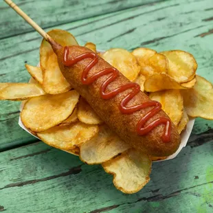 a hot dog with ketchup and potato chips