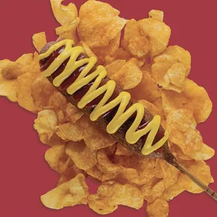 a hot dog on a stick with mustard