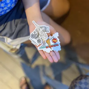 a person's hand with stickers
