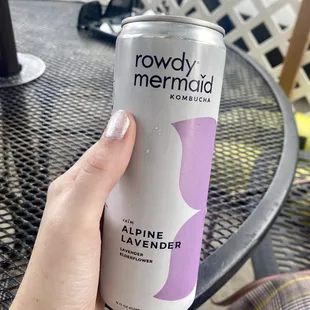 a person holding a can of liquid