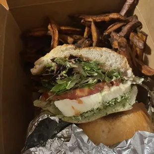a sandwich and french fries in a box