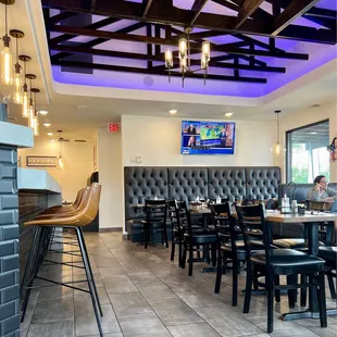 a dining area with tables and chairs