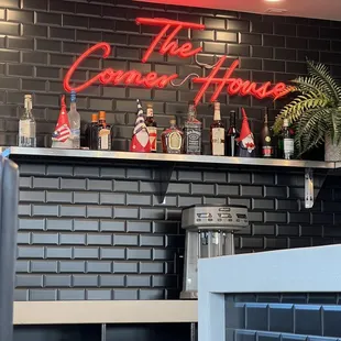 a bar with a neon sign above it
