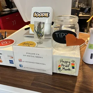 a blender, a jar of liquid, and a cup of coffee on a counter