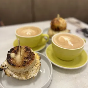 Crumpet egg sandwich, and Cheddar Biscuit, egg and sausage sandwich with Lattes.