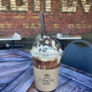 a cup of coffee with whipped cream and chocolate sprinkles