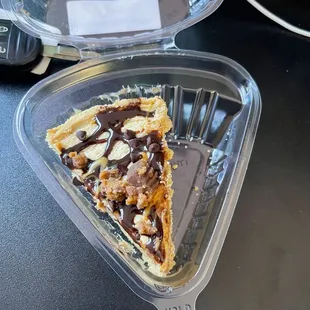 a piece of pie in a plastic container