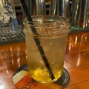 a glass of lemonade with a straw