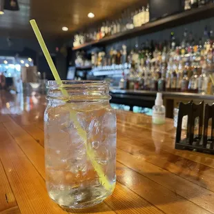 a glass of water with a straw