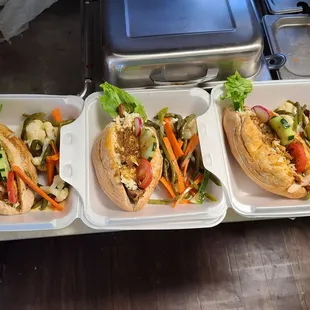 three trays of sandwiches