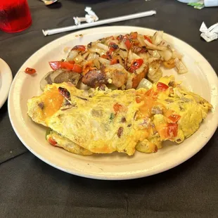 Corner Omelet. Well made, not dry; Potatoes nicely done with peppers and onion.