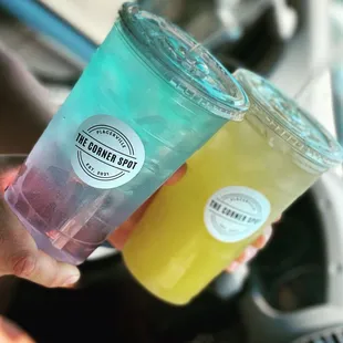 a person holding two drinks