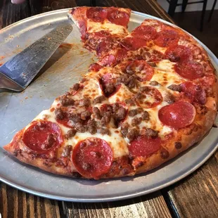 a half eaten pepperoni pizza