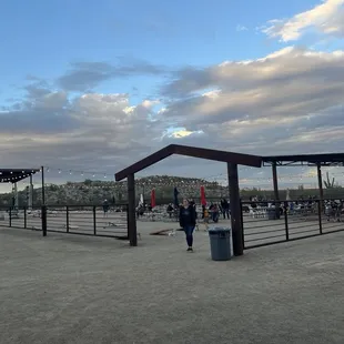 Outdoor stage, cornhole, and seating areas