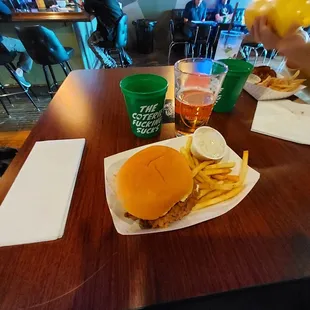 a person eating a hamburger and fries