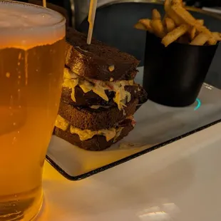 a glass of beer and a sandwich