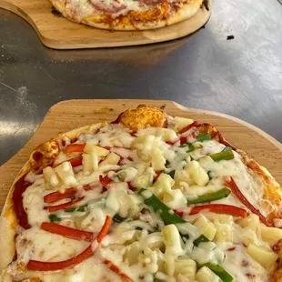 two pizzas on the counter