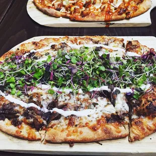 Short rib pizza with fig pesto, fontina, mozzarella, mascarpone, rosemary, and arugula