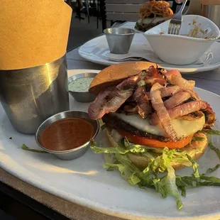 The counter burger with grilled onions and Nashville hot sauce on the side.