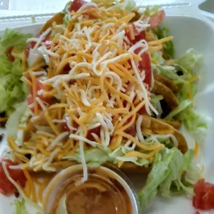 a salad in a styrofoam container