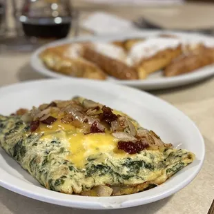 Bacon and cheddar omelette with added onions and spinach.