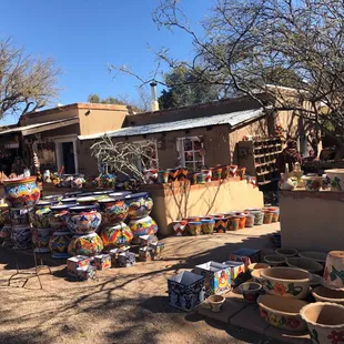 Exterior patio with tons of great pots and decorations for house or yard.