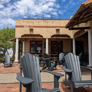 a patio with chairs and tables