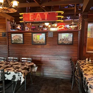 a dining area with tables and chairs
