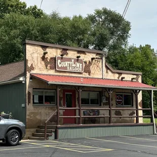 a restaurant with a car parked in front of it
