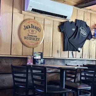 a wooden bar with black chairs