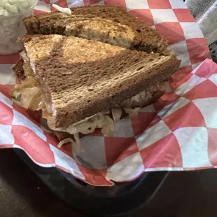 a sandwich and coleslaw in a basket