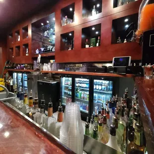 a bar with many bottles of alcohol