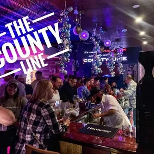 a crowd of people at a bar