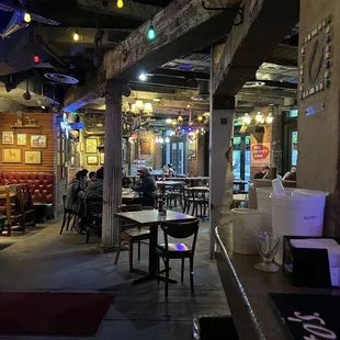 Inside looking from the small cramped bar to  a dining area limited pandemic seating.