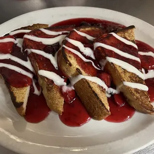 a plate of french toast with strawberry sauce