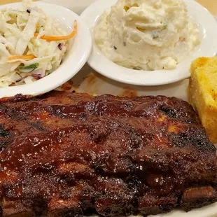 a plate of ribs, coleslaw, and cornbreads