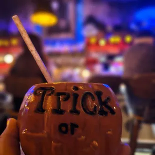 a person holding a coconut drink