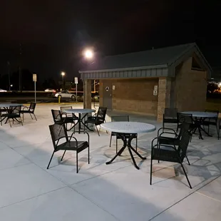 Restrooms and outdoor patio seating. There is a water dispenser on the side of the building closest to the parking lot.
