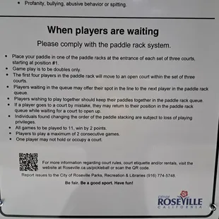 Paddle rack system sign outside the doors, but not sure anyone playing would see you waiting there. Go inside the doors to talk to people.