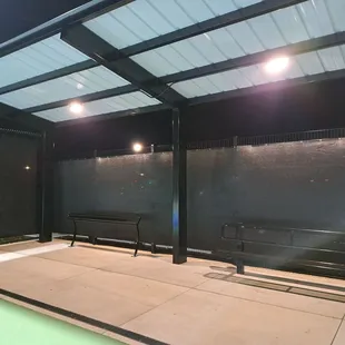 Each group of 3 courts has a covered area with a bench and paddle rack at each end.