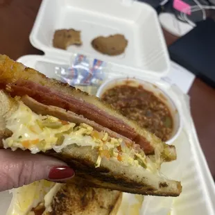 #14 Grilled "Muffale-Cheesy" with Genoa salami and ham melt with smoked Gouda, provolone and gardineria pesto on sourdough.