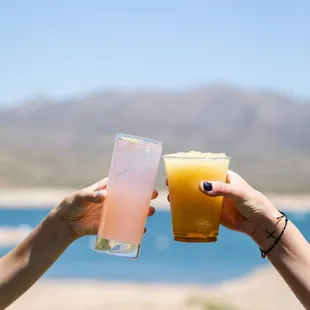 two people toasting with drinks