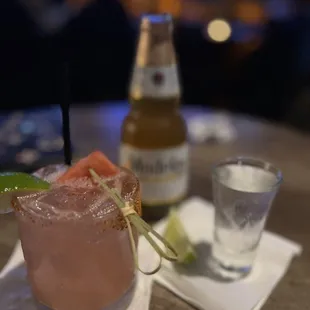 a glass of watermelon and a bottle of beer